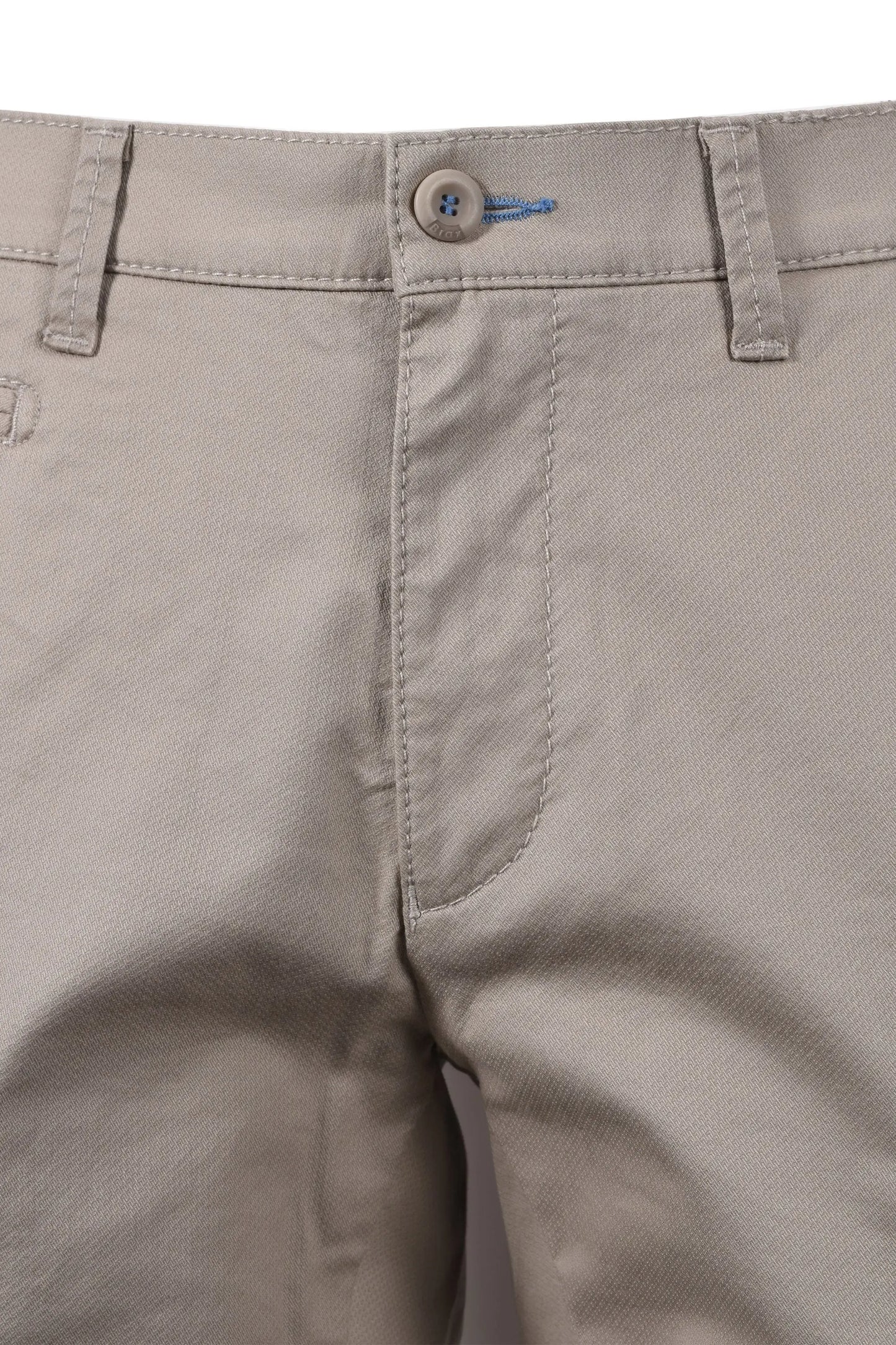 Close-up of beige BRAX FABIO pants with a button and stitching detail on a white background