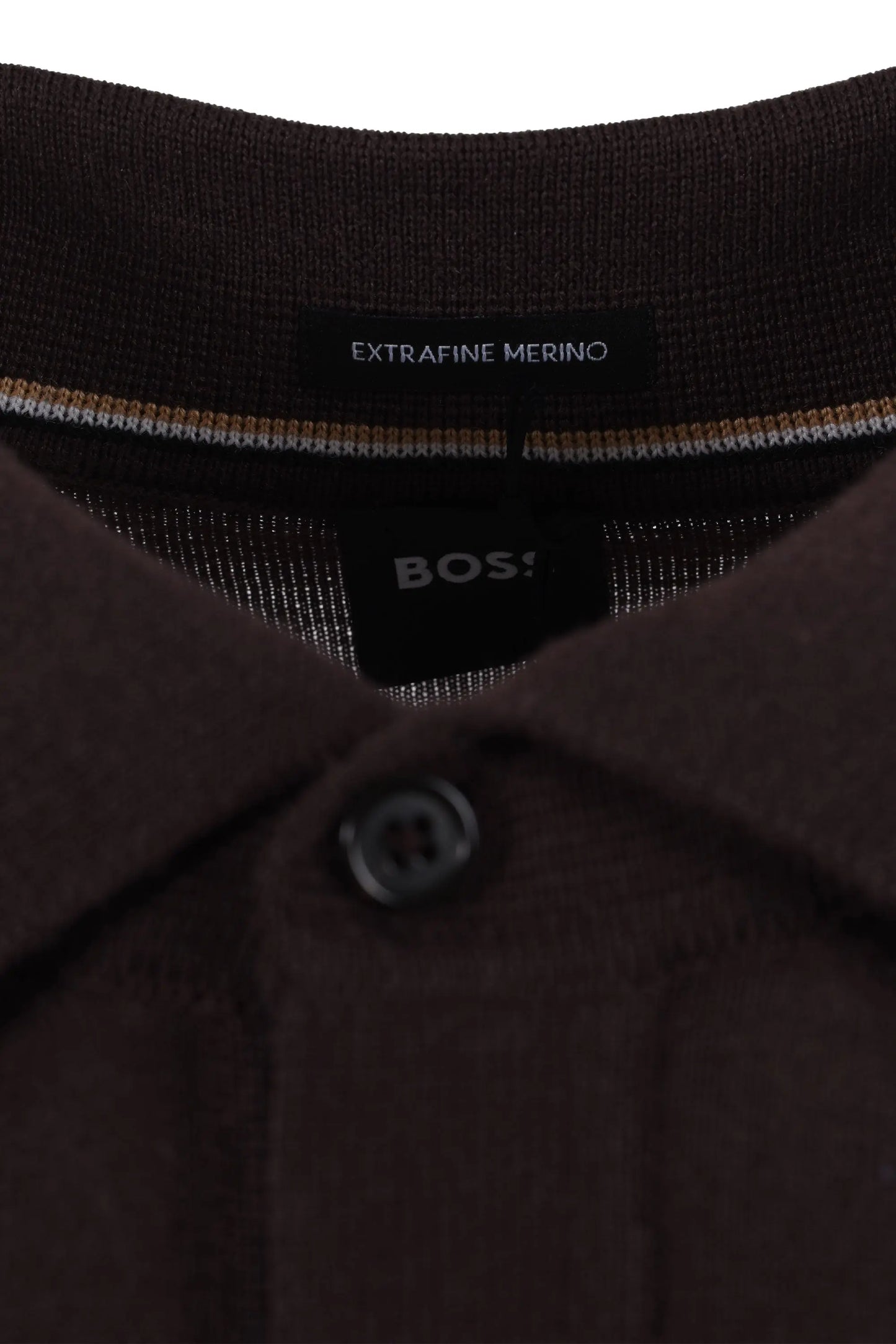 Close-up of a brown polo shirt with 'BOSS' branding and 'Extravine Merino' text.