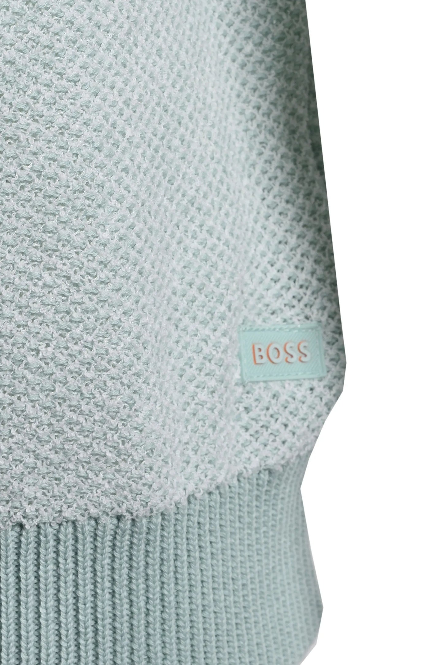 Close-up of a light blue knitted t-shirt with a BOSS label on a white background