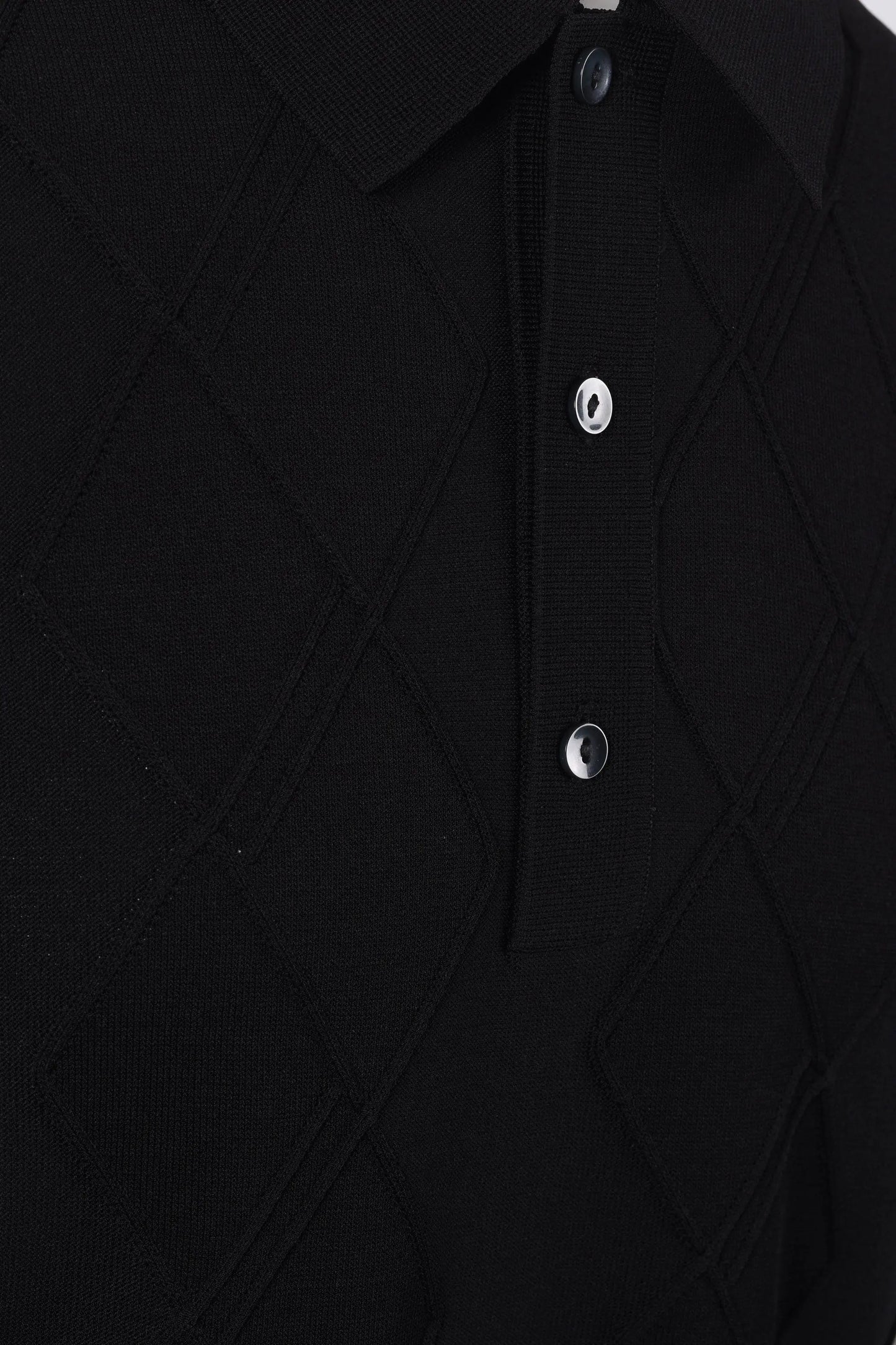 Close-up of a black textured Fred Perry shirt with buttons on a white background