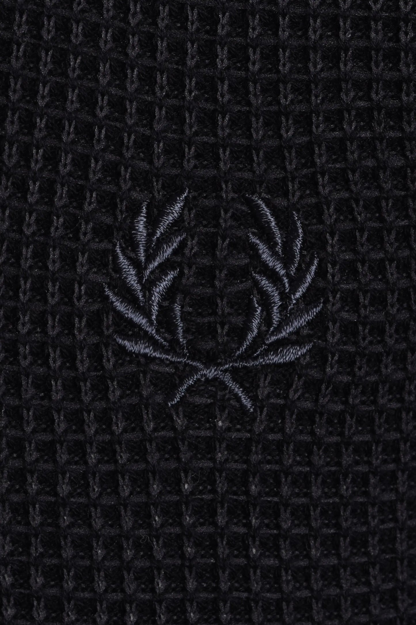 Black textured polo with a subtle fred perry logo