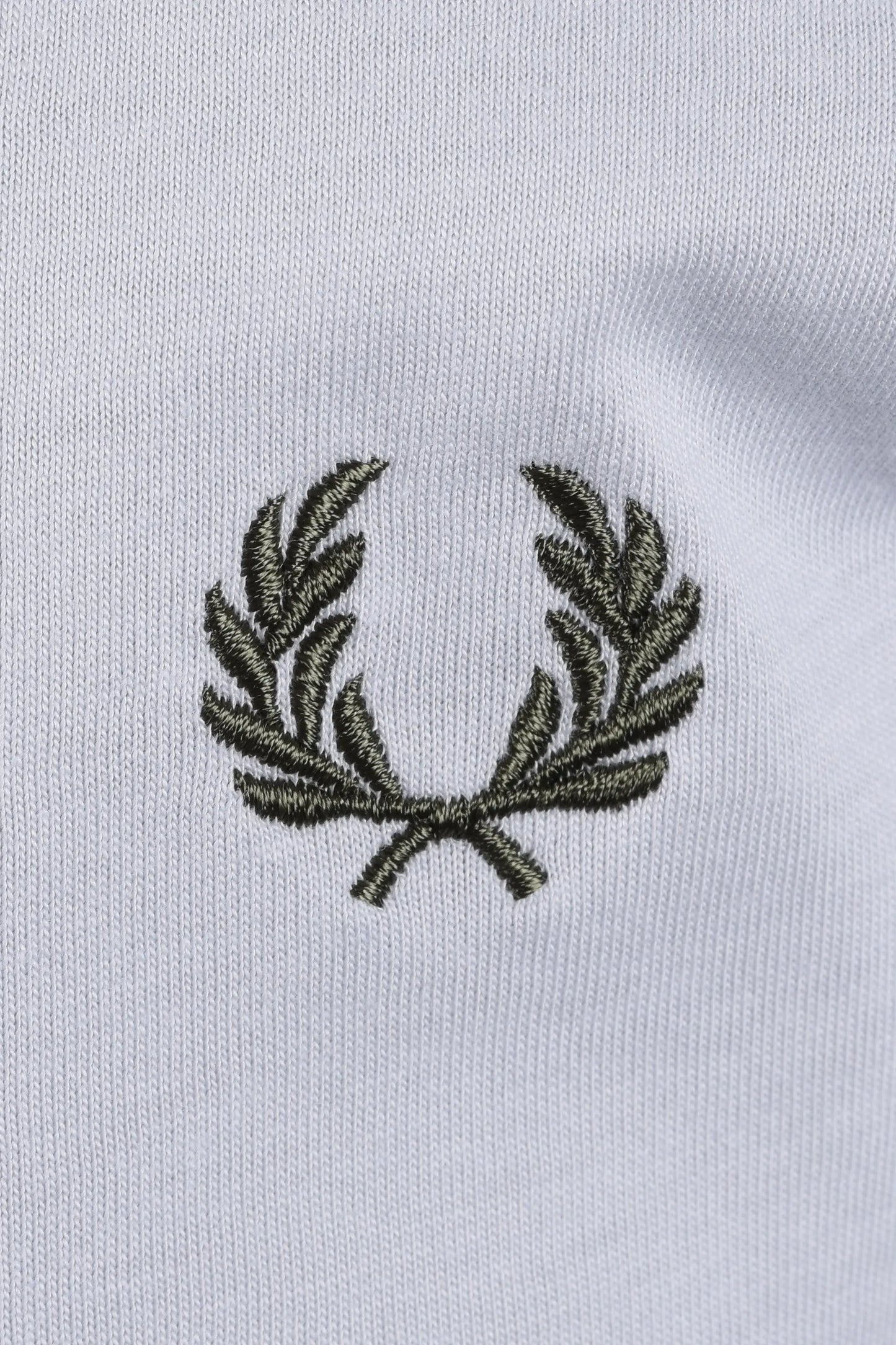 Embroidered green fred perry logo on a light blue t-shirt