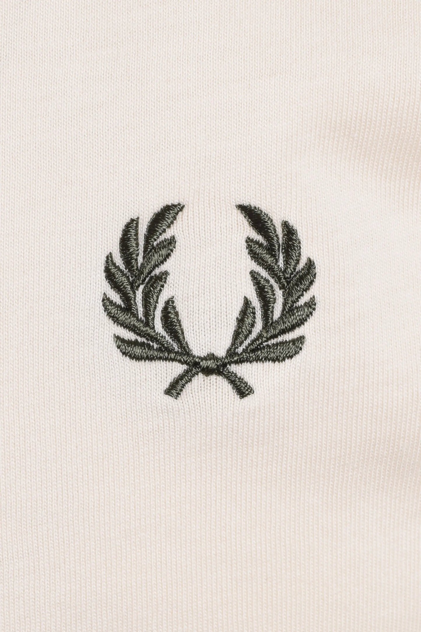 Embroidered green logo on a white t-shirt