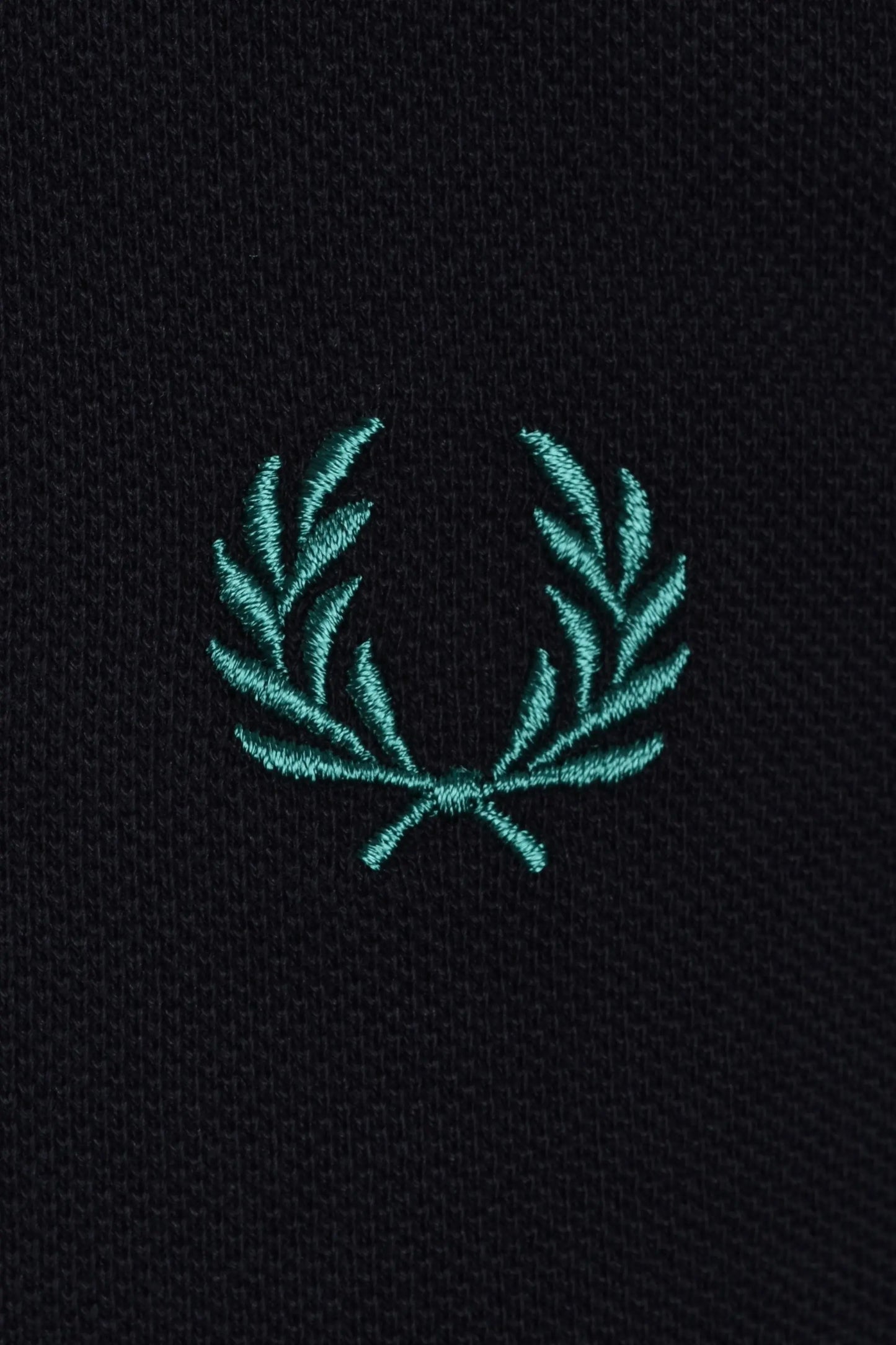 Teal fred perry embroidered logo on a navy polo