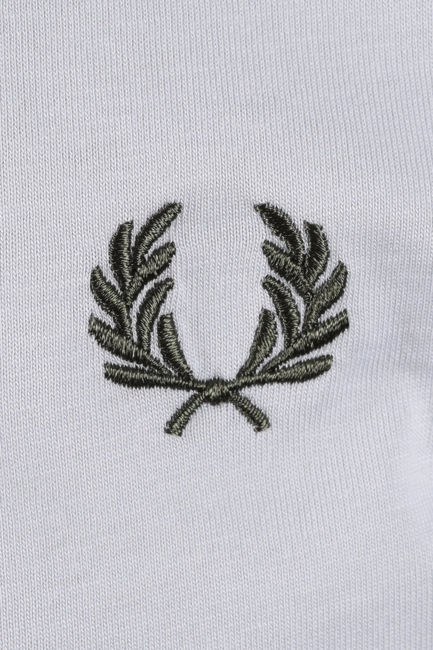 Embroidered green fred perry logo on a light blue t-shirt