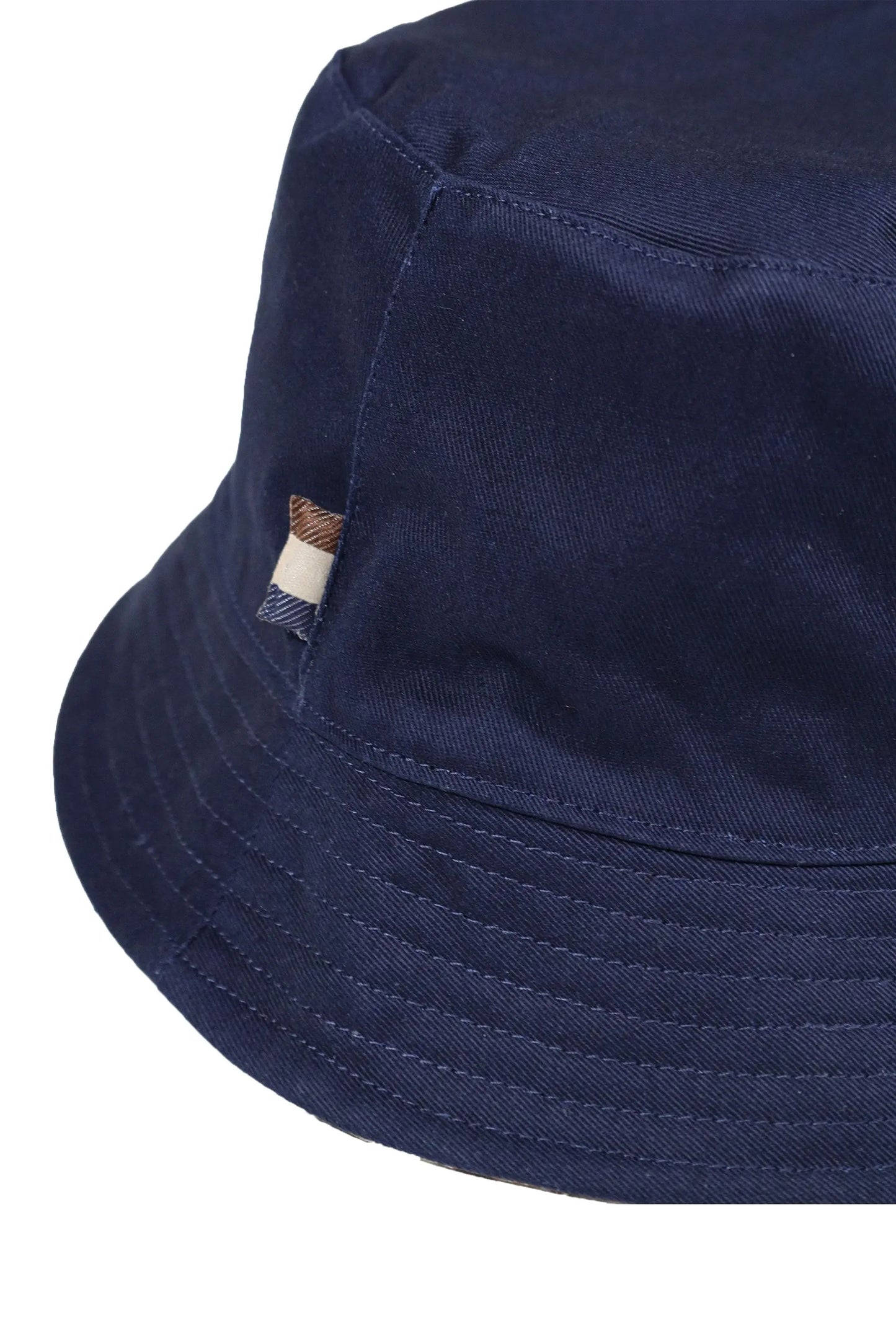 A close up of a Aquascutum branding tab on a navy blue Aquascutum bucket hat.