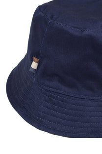 A close up of a Aquascutum branding tab on a navy blue Aquascutum bucket hat.