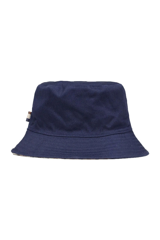 A picture of a Aquascutum bucket hat in the colour dark navy with a Aquascutum brand tag on the seam of the hat.
