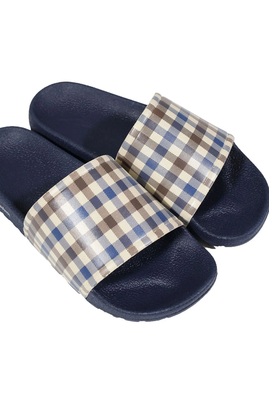 Top side angle photograph of a pair of sliders from the brand Aquascutum with their iconic check pattern on the show of the slider and the sole in the colour navy.