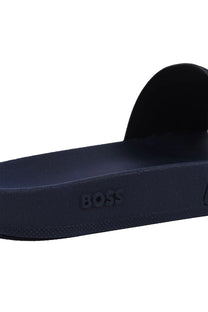 Close up of the Boss branding on the sole of a Boss Aryeh slider in the colour dark blue.