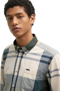 A man wearing a Barbour Harris tartan shirt in the colour Ancient tartan.