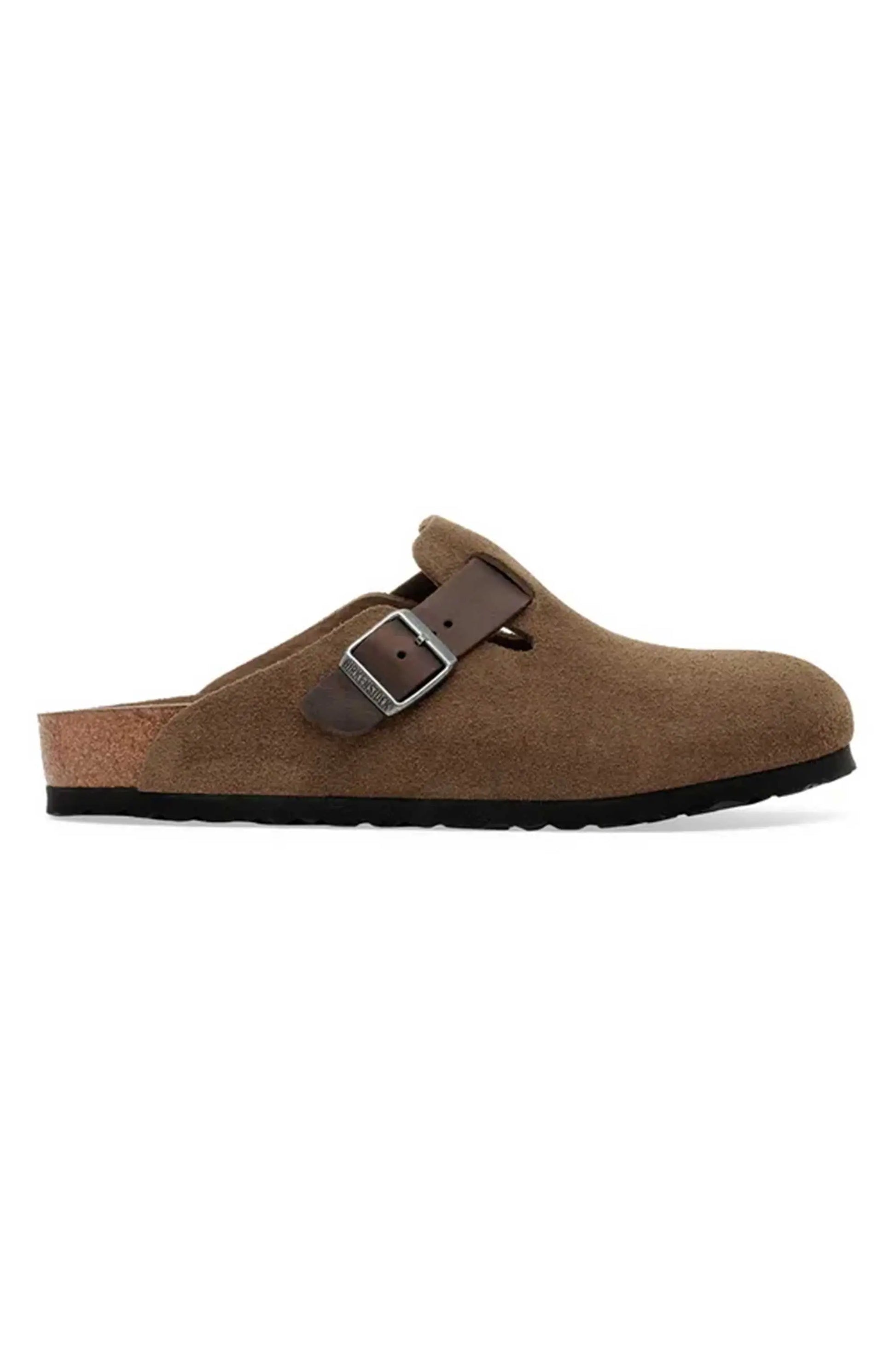 Full side profile picture of the leather Birkenstock Boston clogs in the colour dark tea shows the branded buckle up fastening and the cork sole.