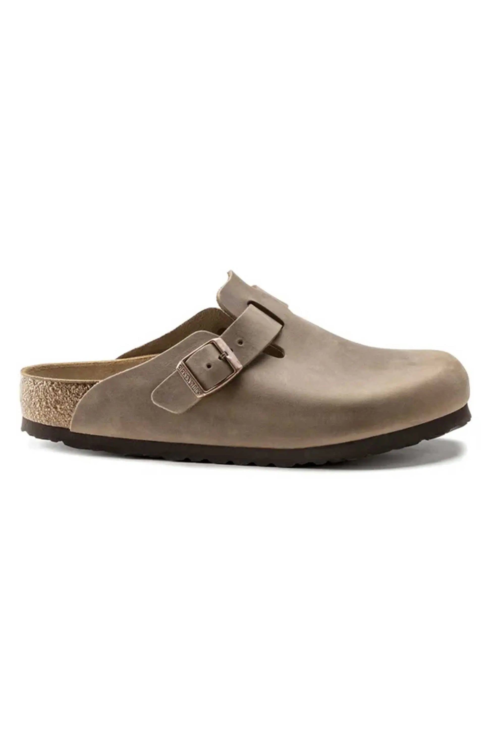 Side profile image of the Birkenstock Boston leather oiled clogs in tobacco brown. It shows the cork sole as well as the tonal Birkenstock branded buckle.