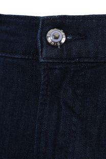 Close up of the button and zip fly closure on a pair of Brax Chuck jeans in a dark denim colour, it has a branded Brax button in the colour blue.