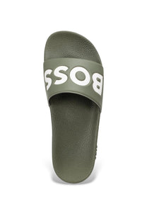 Green slide sandal with 'BOSS' branding in white on a white background