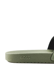 Close up of a Green sandal with 'BOSS' branding on a white background