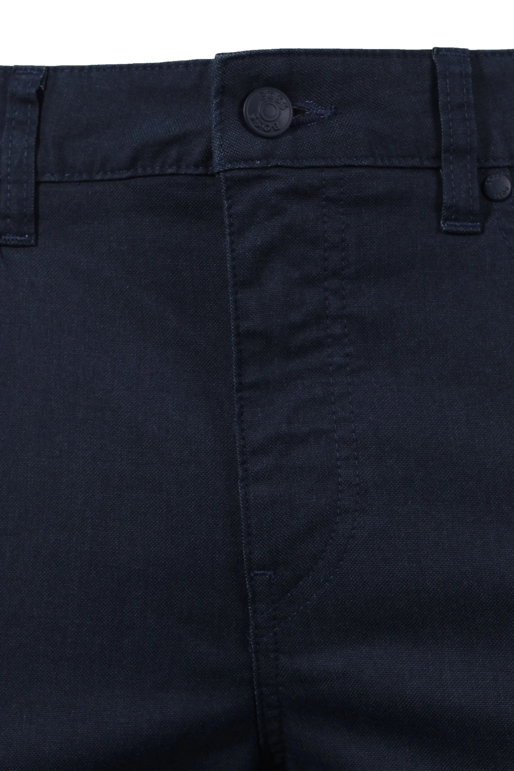 Close-up of dark blue BOSS  pants with a button on a white background