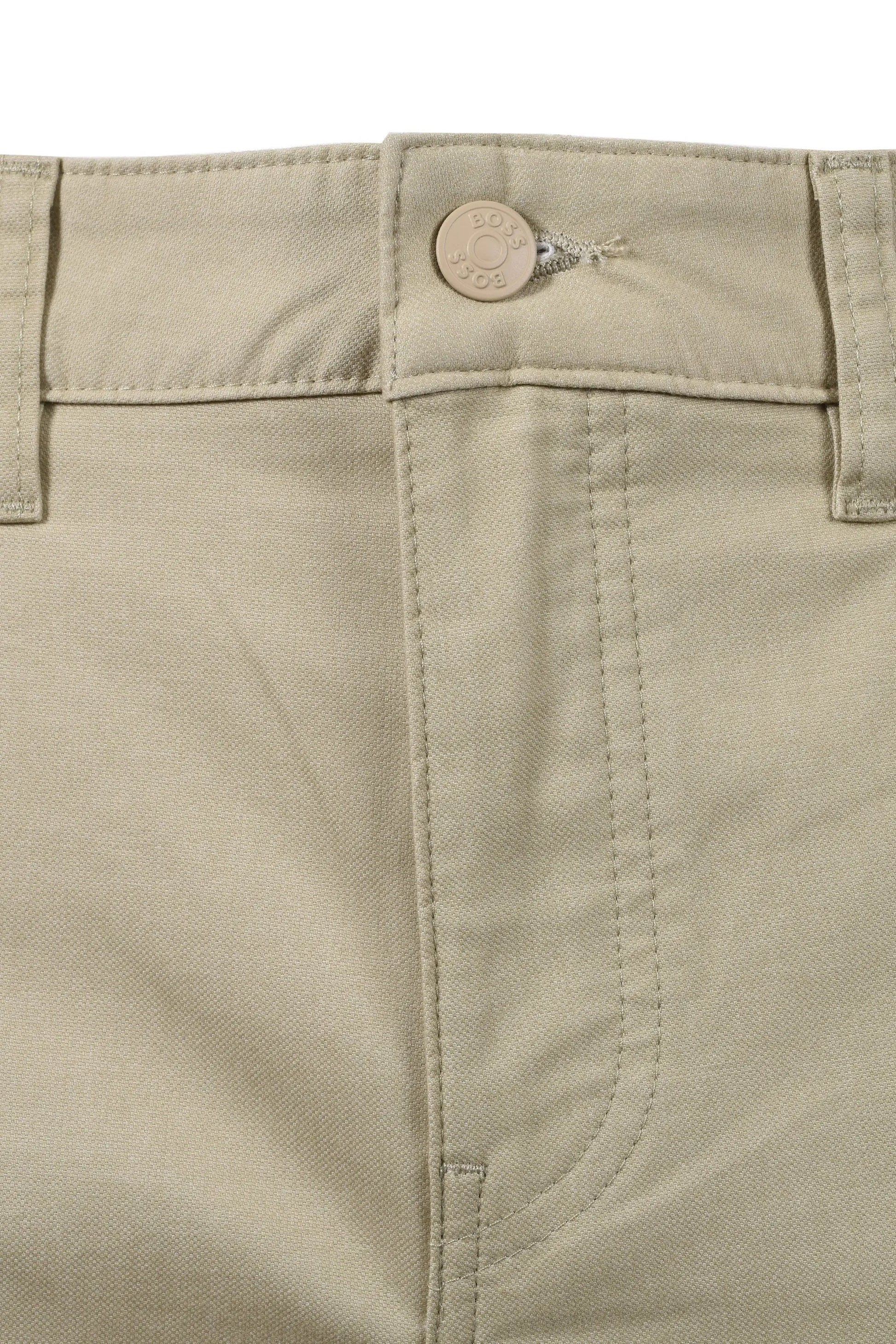 Close-up of beige BOSS trousers with a button and stitching detail