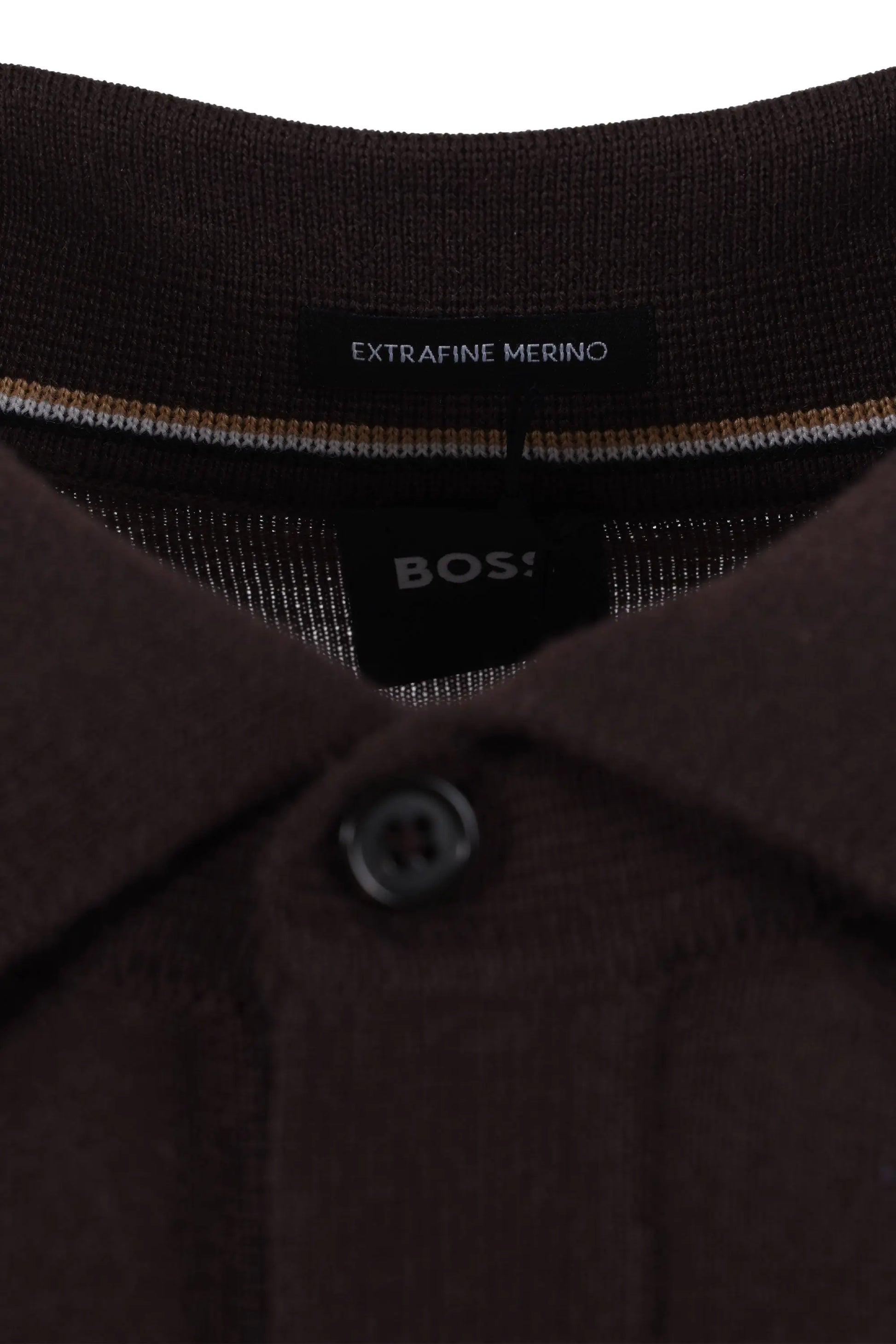 Close-up of a brown polo shirt with 'BOSS' branding and 'Extravine Merino' text.