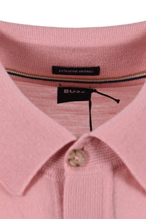 Close-up of a pink polo shirt with a BOSS label on a white background