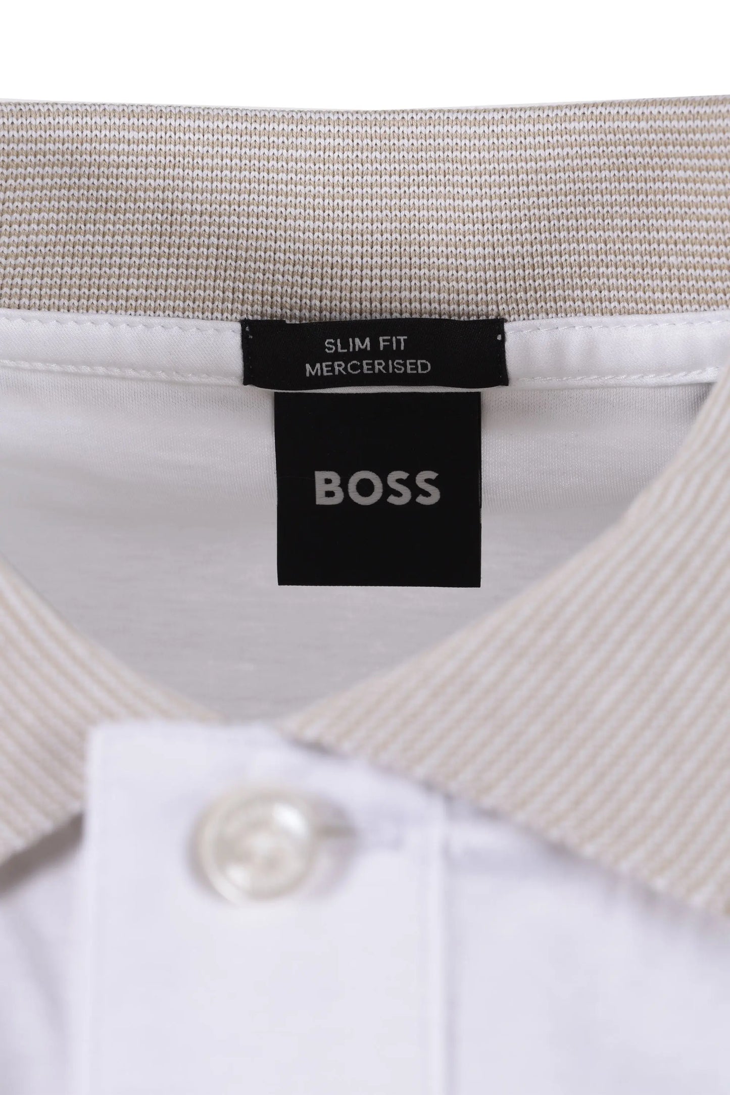 Close-up of a BOSS label on a white polo shirt with a beige collar.