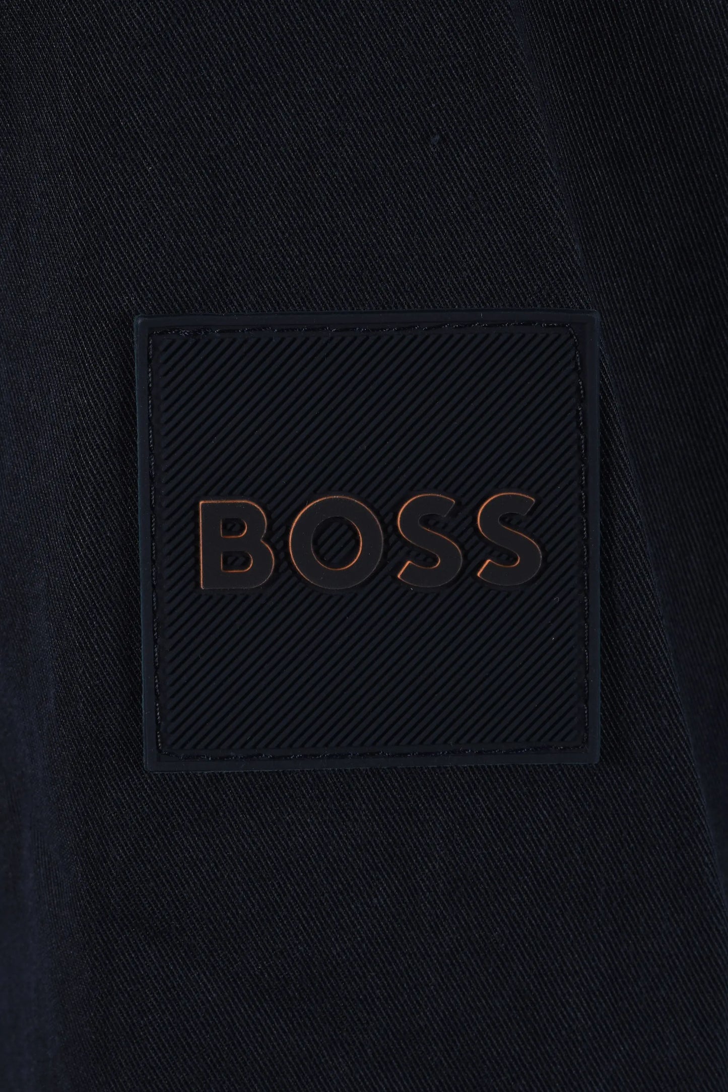 Dark blue jacket with 'BOSS' logo close up