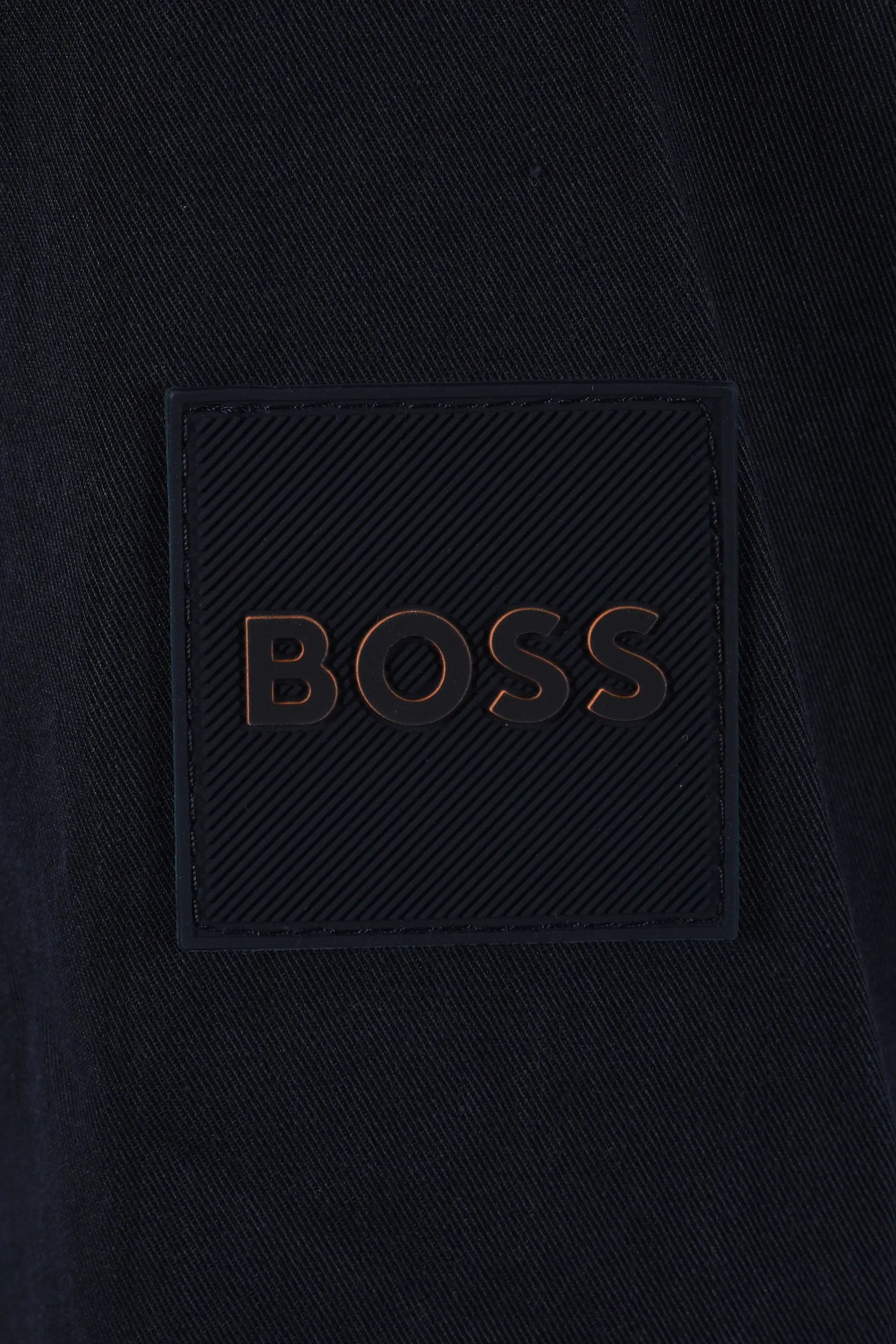 Dark blue jacket with 'BOSS' logo close up