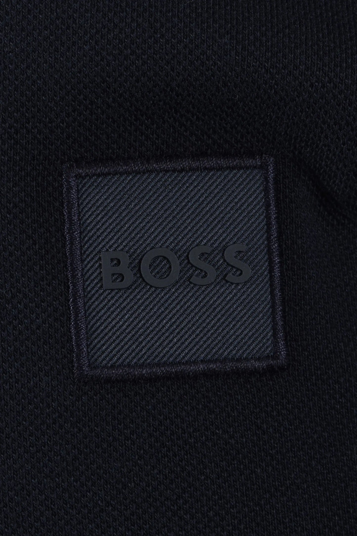 BOSS logo on a textured black fabric patch
