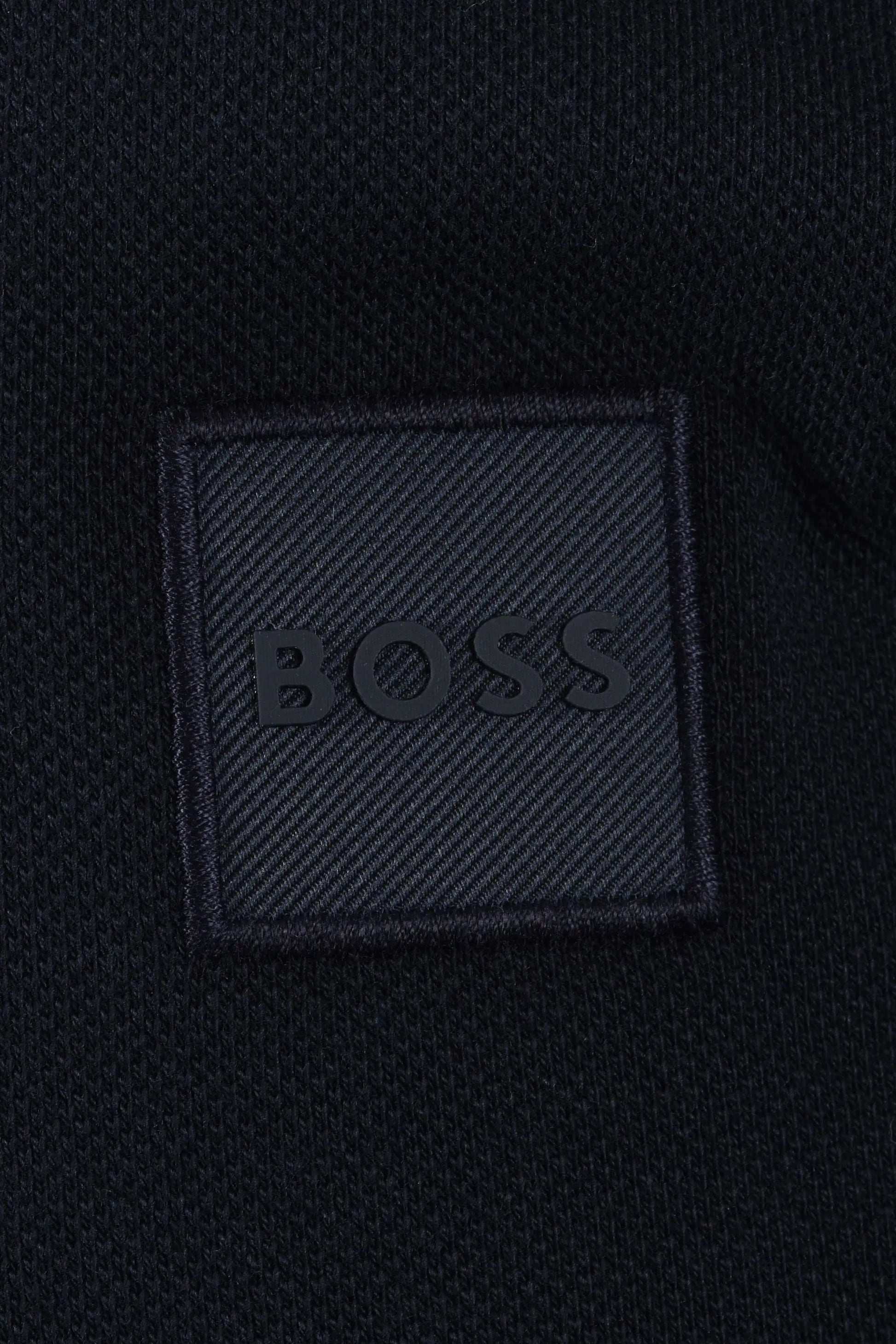 BOSS logo on a textured black fabric patch