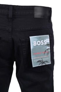 Dark blue jeans with a BOSS label on a white background