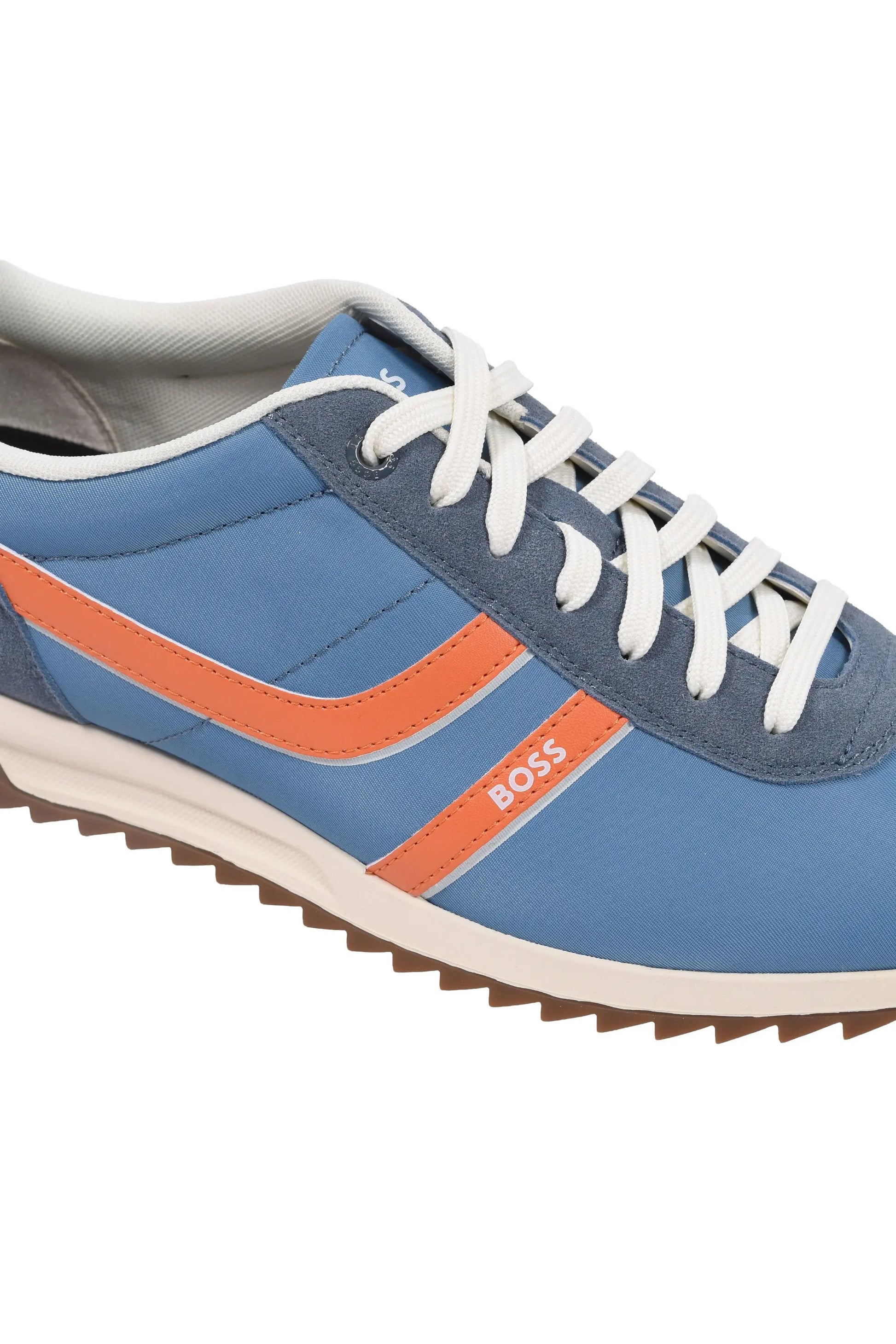 Side angle of the blue and orange Boss Orange Zayn trainers. Shows a close up of the stripe pattern on the side and the Boss branding of the side of the shoe.