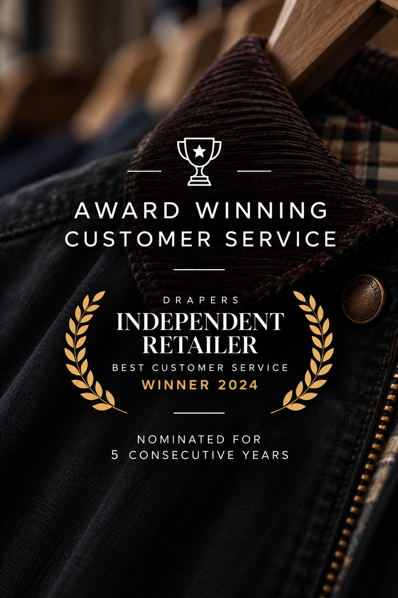 Award-winning customer service badge for Drapers Independent Retailer, Winner 2024, displayed over a close-up of a dark brown corduroy collar and black denim jacket.
