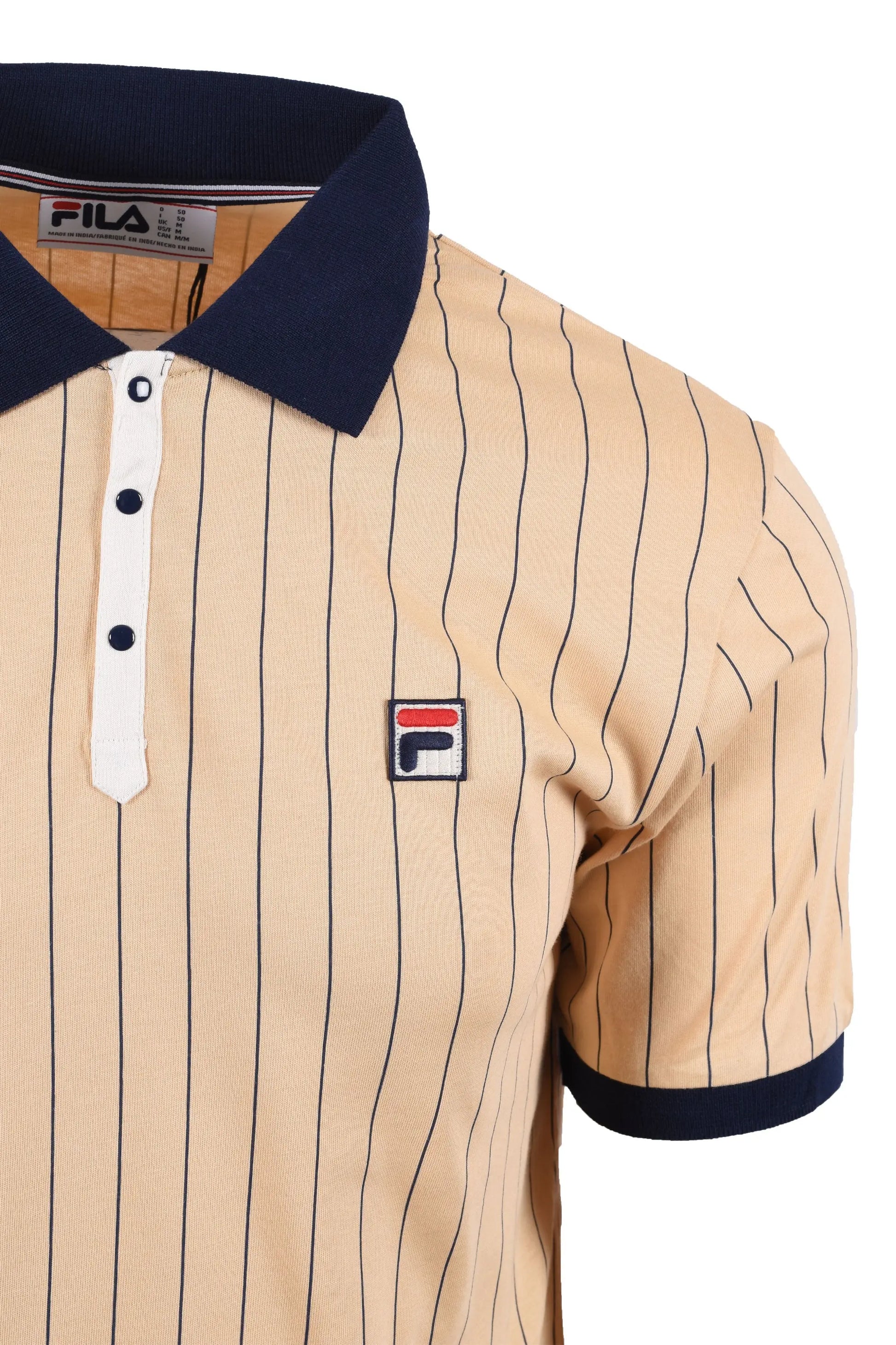 Side picture of the Fila classic BB1 striped polo in beige. It has a press stud button placket, retro stripped patterned fabric and the Fila embroidered logo at the chest.