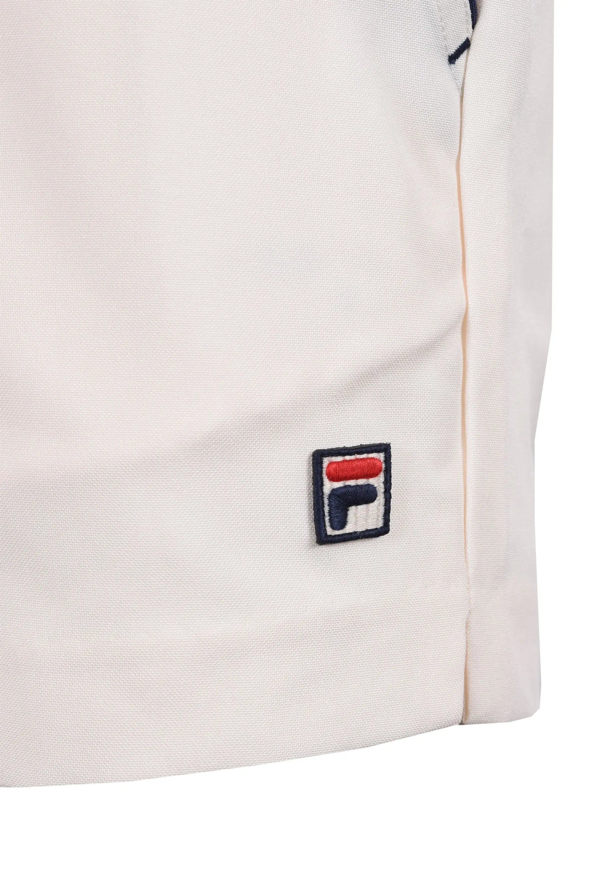 Close up of the embroidered Fila logo on a pair of Fila hightide terry pocket stripe shorts.