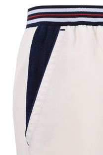 The waistband and pocket detailing on a pair of Fila terry pocket stripe shorts.