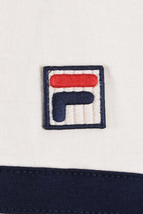 Close up of the Fila logo embraided on fabric with a gardenia background