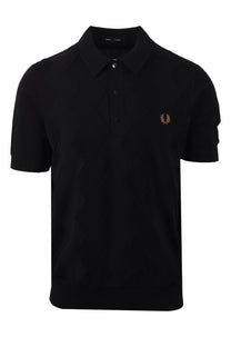 Black Fred Perry polo shirt with a small gold logo on a white background