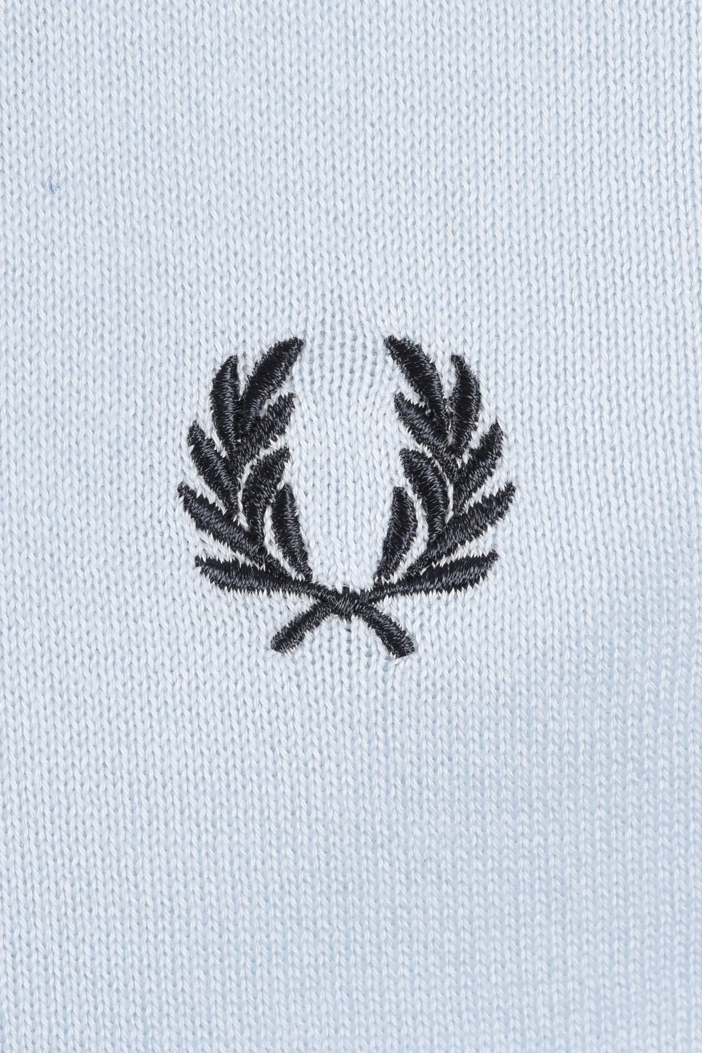 Embroidered fred perry logo on a light blue polo
