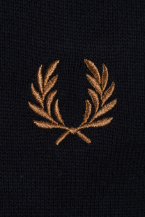 Embroidered gold  fred perry logo on a navy polo