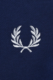 Embroidered fred perry logo on a navy swaetshirt close up
