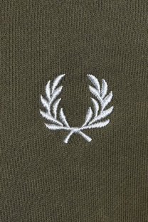 Close-up of a fred perry logo on a dark green sweatshirt