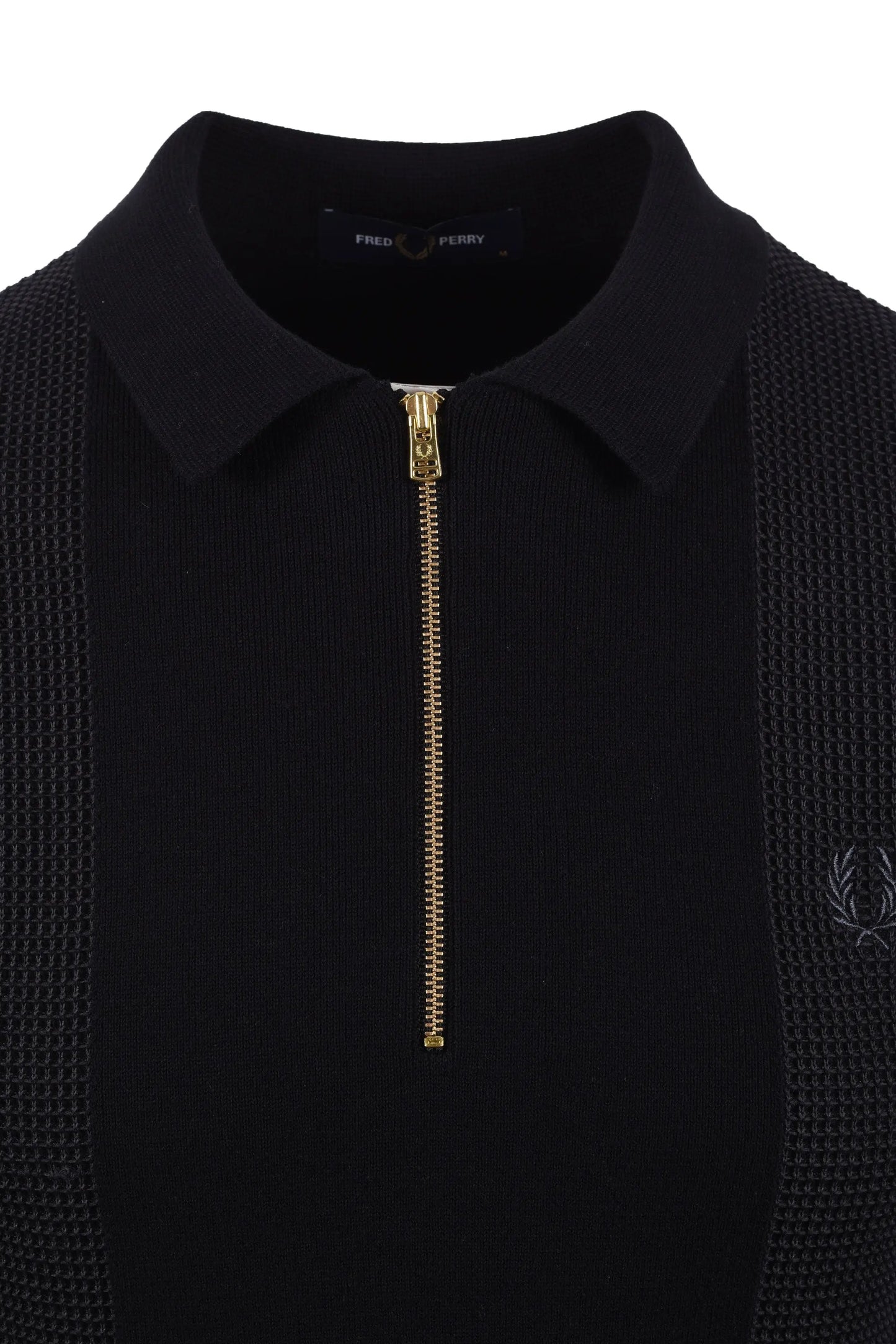 Black polo shirt with gold zipper and fred perry logo on a white background