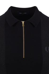 Black polo shirt with gold zipper and fred perry logo on a white background