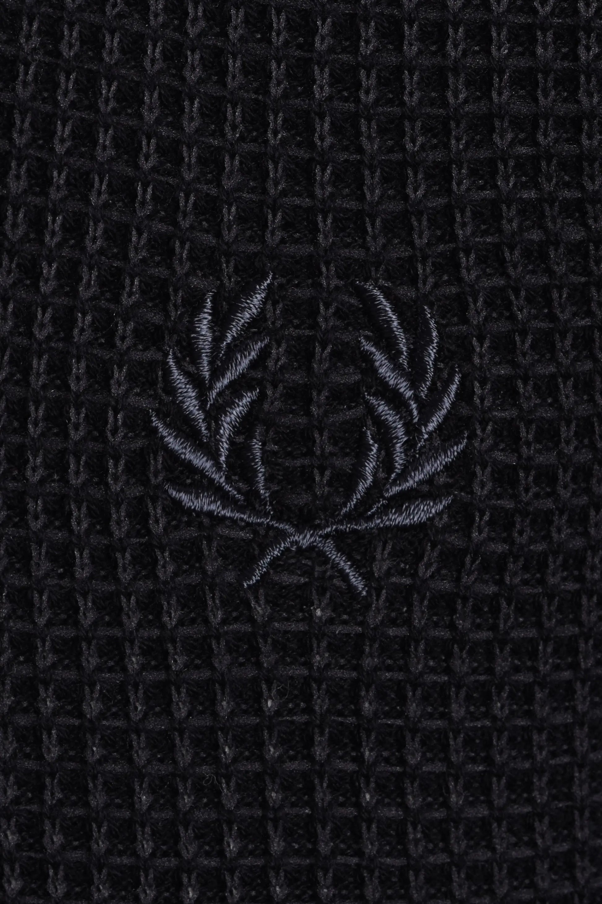 Black textured polo with a subtle fred perry logo