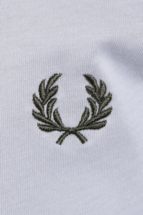 Embroidered green fred perry logo on a light blue t-shirt 
