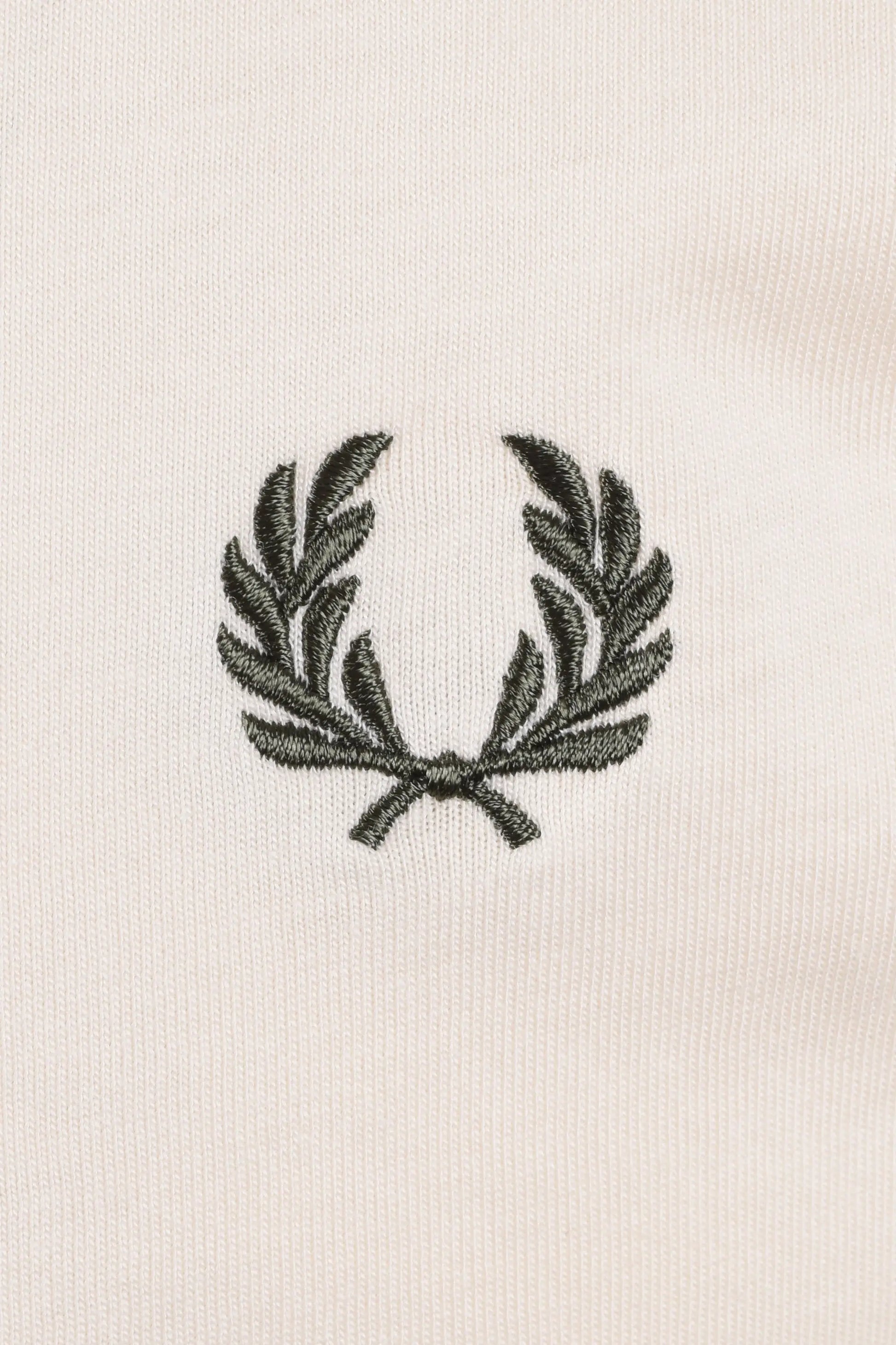 Embroidered green logo on a white t-shirt