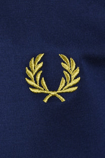 Close up of the embroidered Fred Perry laurel wreath logo in the colourways French navy.