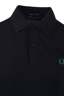 Close up of the collar and placket of a Navy coloured Fred Perry polo. Shows the label in the collar of the polo shirt.