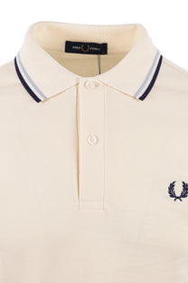 Beige polo shirt with a small fred perry  logo on a white background