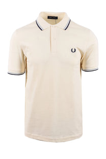 Beige polo shirt with fred perry logo on a white background
